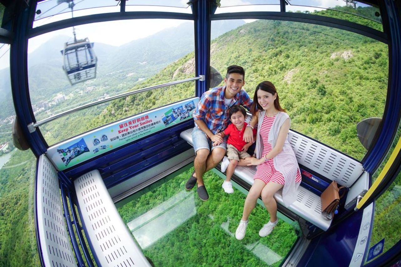 Family on the glass floor of a Ngong Ping 360 Crystal Cabin